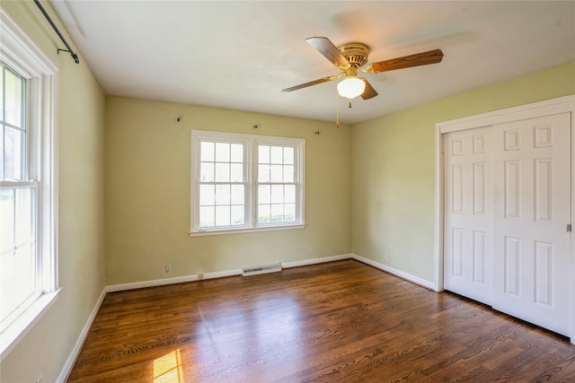 7218 El Rancho Ave, Windsor Heights, IA 50324 - unfurnished bedroom featuring wood finished floors, a closet, baseboards, and a ceiling fan