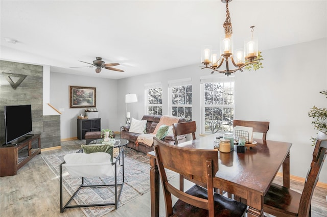 5558 Boston Ct, Johnston, IA 50131 - dining space with light wood finished floors, baseboards, a chandelier, and ceiling fan