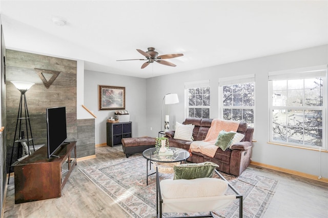 5558 Boston Ct, Johnston, IA 50131 - living area featuring healthy amount of natural light, a ceiling fan, baseboards, and wood finished floors