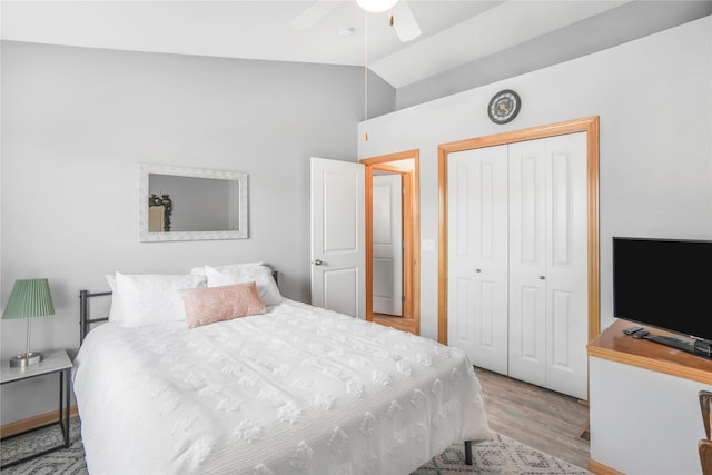 5558 Boston Ct, Johnston, IA 50131 - bedroom featuring a closet, wood finished floors, high vaulted ceiling, and ceiling fan
