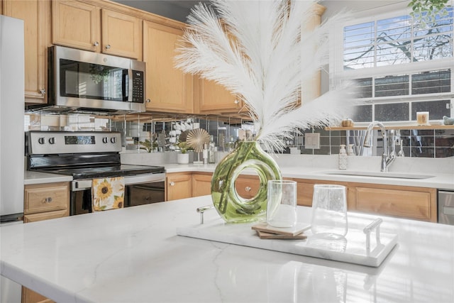 5558 Boston Ct, Johnston, IA 50131 - kitchen featuring appliances with stainless steel finishes, a sink, decorative backsplash, and light brown cabinetry