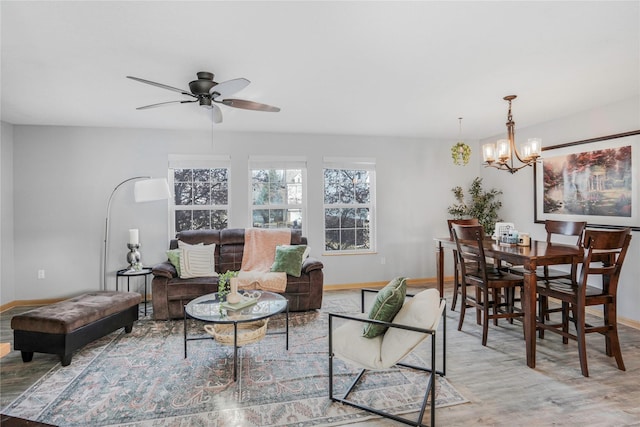 5558 Boston Ct, Johnston, IA 50131 - living area with wood finished floors, baseboards, and a chandelier