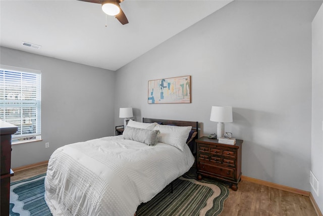 5558 Boston Ct, Johnston, IA 50131 - bedroom with wood finished floors, lofted ceiling, baseboards, and a ceiling fan