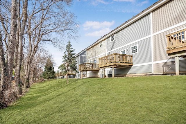 5558 Boston Ct, Johnston, IA 50131 - rear view of house featuring a wooden deck and a yard