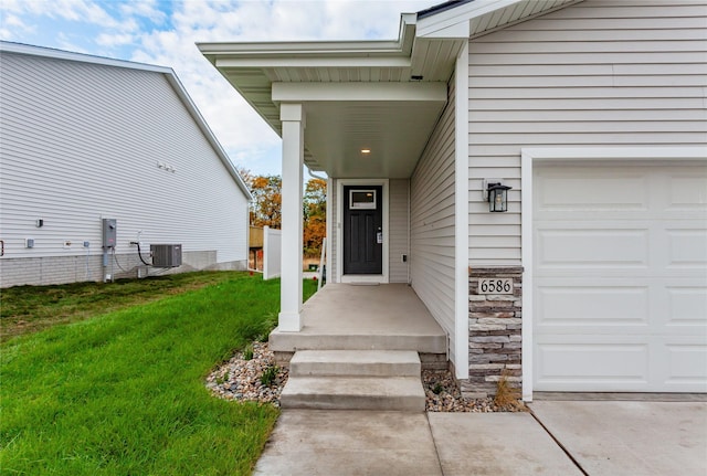 2717 13th St NE, Bondurant, IA 50035 - view of exterior entry featuring a garage, stone siding, and a yard