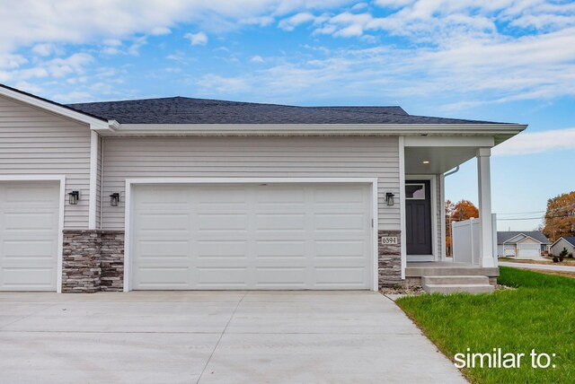 garage featuring concrete driveway