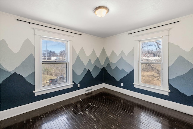 951 24th St, Des Moines, IA 50312 - spare room featuring dark wood-style flooring, baseboards, healthy amount of natural light, and crown molding