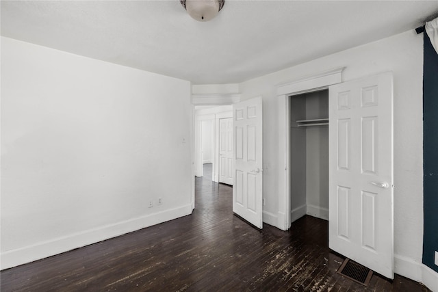 951 24th St, Des Moines, IA 50312 - unfurnished bedroom featuring wood-type flooring, baseboards, and a closet