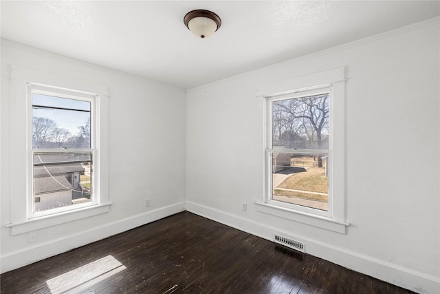 951 24th St, Des Moines, IA 50312 - unfurnished room with healthy amount of natural light, dark wood finished floors, baseboards, and ornamental molding