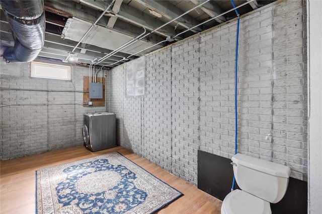 951 24th St, Des Moines, IA 50312 - below grade area featuring wood finished floors, electric panel, and brick wall