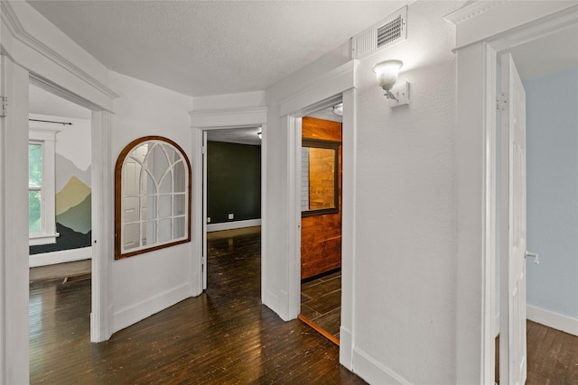 951 24th St, Des Moines, IA 50312 - corridor featuring dark wood finished floors, baseboards, and a textured ceiling
