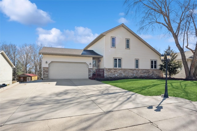 traditional-style house featuring a garage, stone siding, concrete driveway, and a front lawn