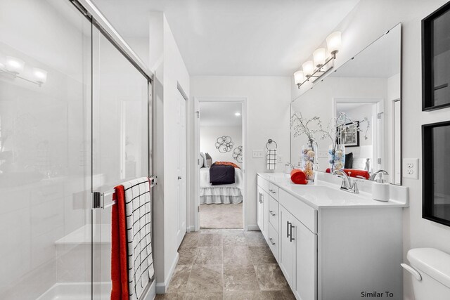 bathroom featuring toilet, a shower stall, double vanity, and connected bathroom