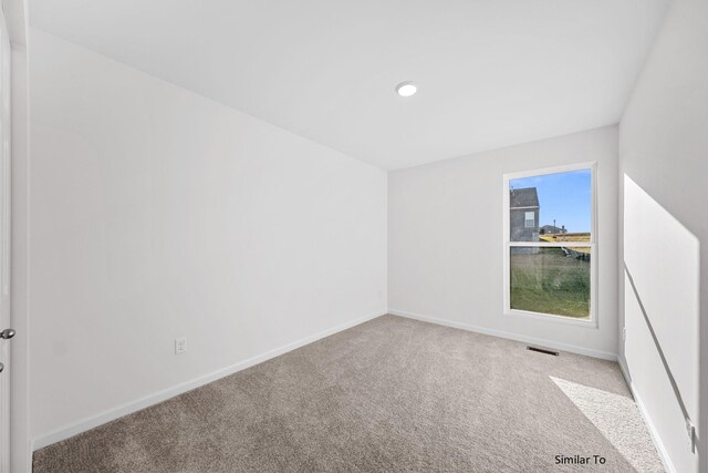 spare room featuring carpet, baseboards, and recessed lighting