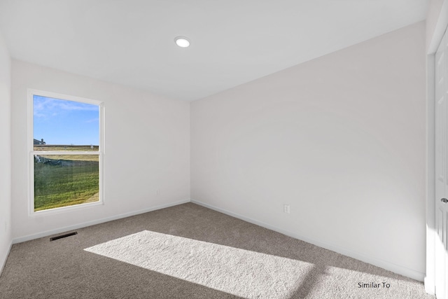 carpeted spare room featuring baseboards and recessed lighting