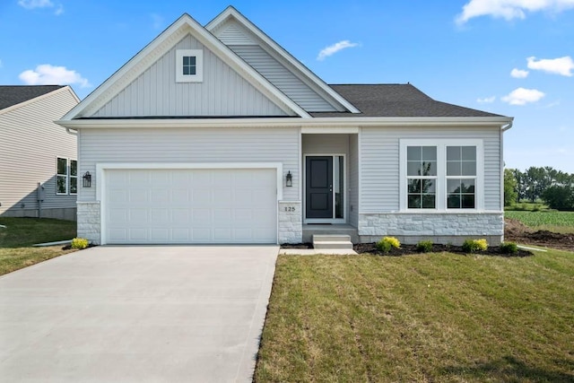 125 NW Rolling Cir, Waukee, IA 50263 - view of front of house with a front yard, driveway, stone siding, board and batten siding, and an attached garage