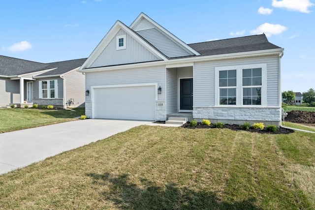 125 NW Rolling Cir, Waukee, IA 50263 - view of front of property featuring concrete driveway, an attached garage, a front lawn, and stone siding