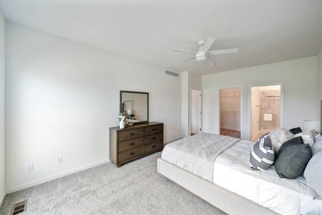 125 NW Rolling Cir, Waukee, IA 50263 - carpeted bedroom with a walk in closet, a ceiling fan, a closet, and ensuite bathroom
