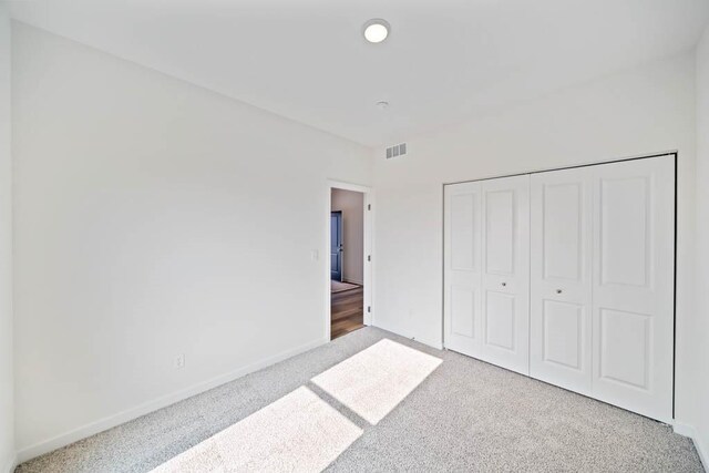 125 NW Rolling Cir, Waukee, IA 50263 - unfurnished bedroom featuring carpet and a closet