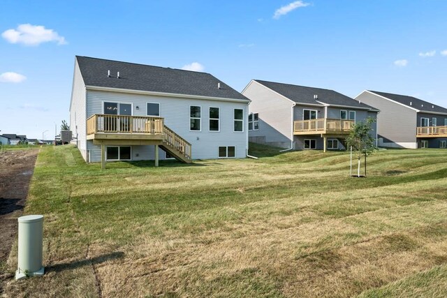 125 NW Rolling Cir, Waukee, IA 50263 - rear view of house featuring stairs, a deck, and a yard