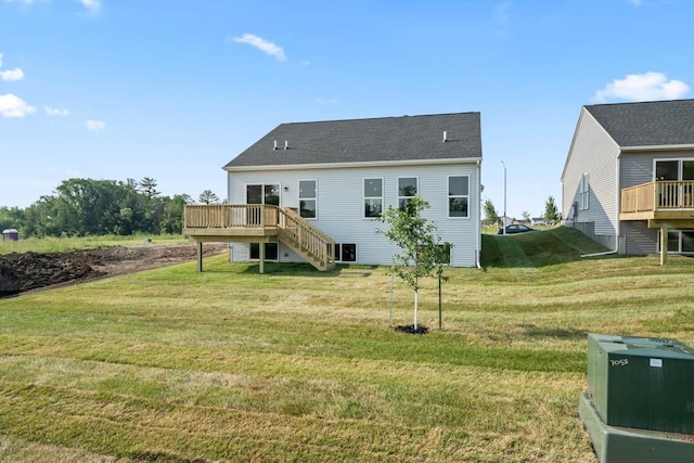 125 NW Rolling Cir, Waukee, IA 50263 - back of property with a wooden deck, stairway, and a lawn