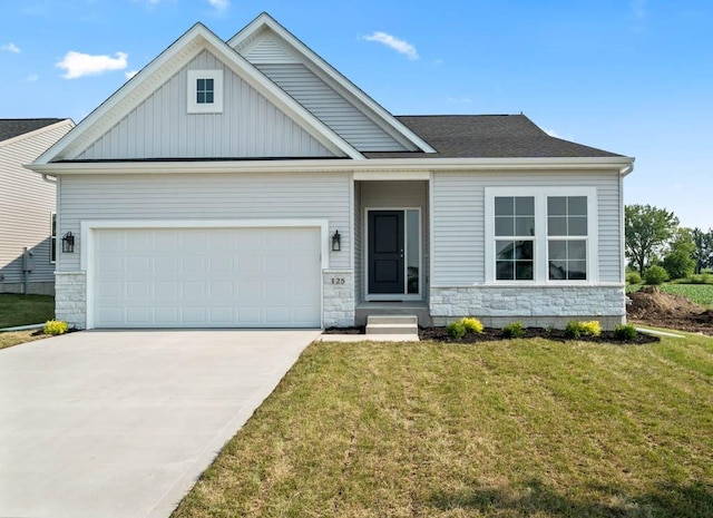 125 NW Rolling Cir, Waukee, IA 50263 - view of front of house with concrete driveway, a front lawn, board and batten siding, a garage, and stone siding