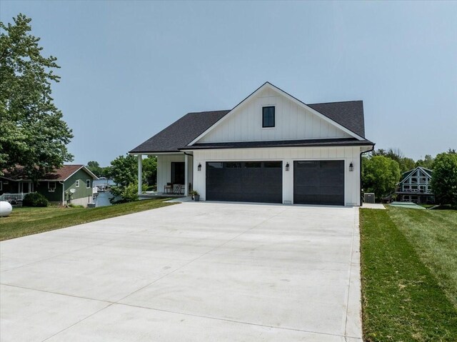 1296 Bee Tree Ln, Ellston, IA 50074 - modern inspired farmhouse with board and batten siding, a front yard, driveway, and a shingled roof