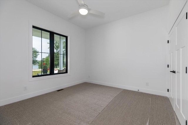 1296 Bee Tree Ln, Ellston, IA 50074 - carpeted spare room with a ceiling fan and baseboards