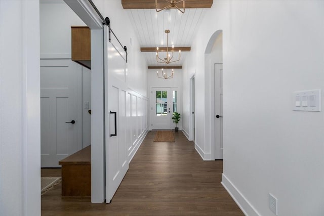 1296 Bee Tree Ln, Ellston, IA 50074 - hall with dark wood finished floors, beamed ceiling, a chandelier, arched walkways, and a barn door