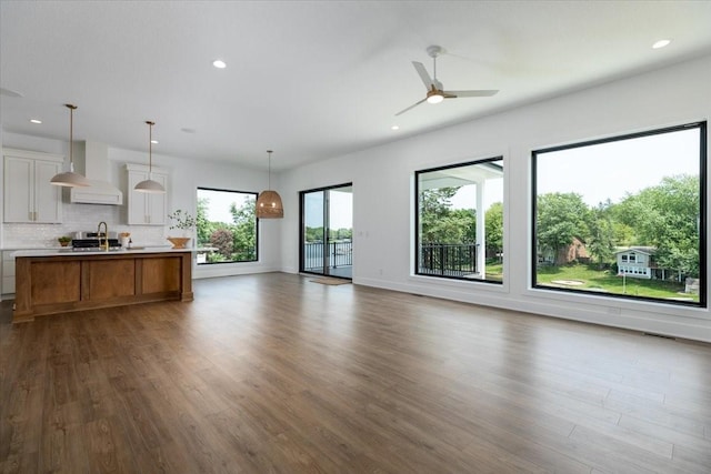 1296 Bee Tree Ln, Ellston, IA 50074 - kitchen with wall chimney range hood, open floor plan, light countertops, dark wood-style flooring, and recessed lighting