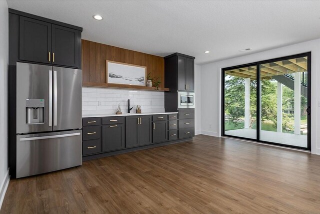 1296 Bee Tree Ln, Ellston, IA 50074 - kitchen with stainless steel appliances, light countertops, tasteful backsplash, dark wood-style flooring, and open shelves