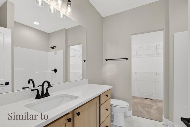 2926 Lake Hill Dr, Des Moines, IA 50320 - full bath with marble look tile flooring, vanity, a shower, and a walk in closet