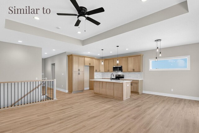 2926 Lake Hill Dr, Des Moines, IA 50320 - kitchen featuring stainless steel appliances, light countertops, recessed lighting, light wood-style floors, and decorative backsplash