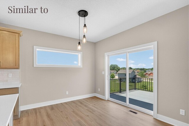 2926 Lake Hill Dr, Des Moines, IA 50320 - unfurnished dining area featuring light wood-style floors and plenty of natural light
