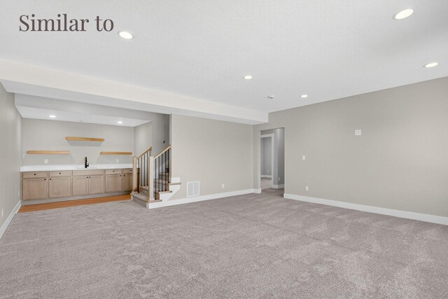 2926 Lake Hill Dr, Des Moines, IA 50320 - unfurnished living room with light carpet, bar with sink, stairway, and recessed lighting