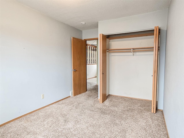 unfurnished bedroom featuring a closet, carpet flooring, and a textured ceiling