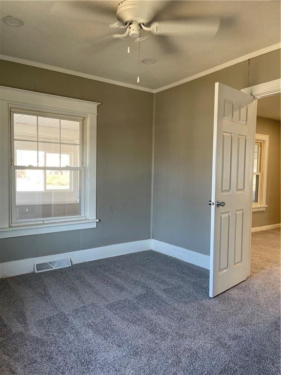 1144 Euclid Ave, Des Moines, IA 50313 - unfurnished room featuring visible vents, crown molding, carpet, baseboards, and ceiling fan