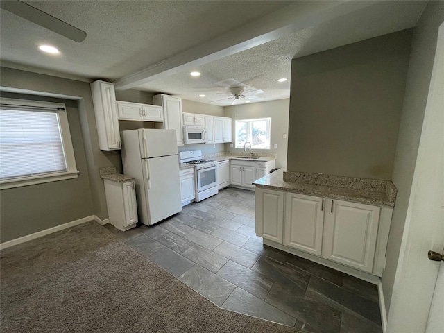 1144 Euclid Ave, Des Moines, IA 50313 - kitchen featuring white cabinetry, white appliances, a textured ceiling, a sink, and a ceiling fan