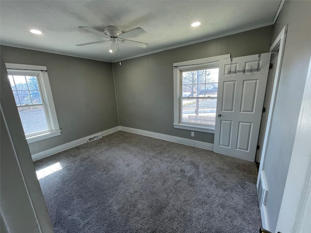 1144 Euclid Ave, Des Moines, IA 50313 - unfurnished bedroom featuring visible vents, crown molding, carpet floors, and a textured ceiling
