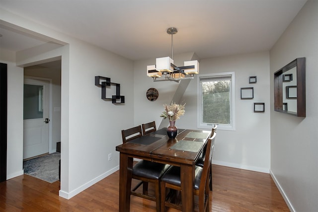3265 Dartmoor Rd, Ames, IA 50014 - dining room with a chandelier, wood finished floors, and baseboards