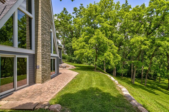 3265 Dartmoor Rd, Ames, IA 50014 - view of green lawn featuring a patio and view of wooded area