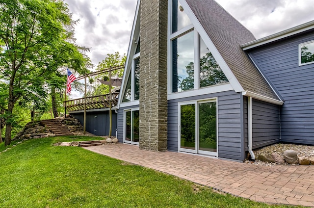 3265 Dartmoor Rd, Ames, IA 50014 - back of house with a patio and a lawn