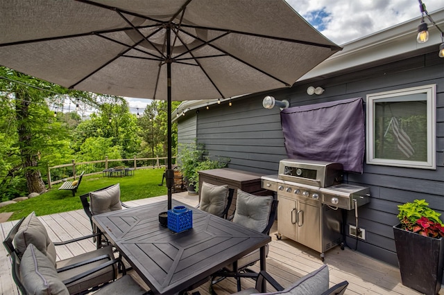 3265 Dartmoor Rd, Ames, IA 50014 - deck with outdoor dining area, a grill, and a lawn