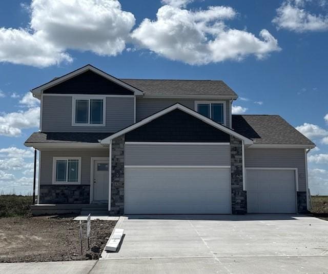 1420 Werthman Dr, Waukee, IA 50263 - craftsman-style home with an attached garage, concrete driveway, stone siding, and covered porch