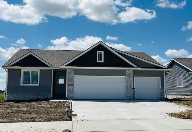 view of front of property featuring an attached garage and concrete driveway