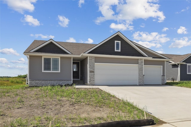 1430 Werthman Dr, Waukee, IA 50263 - view of front of property with a garage, concrete driveway, stone siding, and roof with shingles