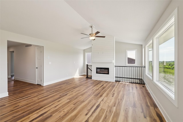 1430 Werthman Dr, Waukee, IA 50263 - unfurnished living room with light wood finished floors, a ceiling fan, vaulted ceiling, and a fireplace