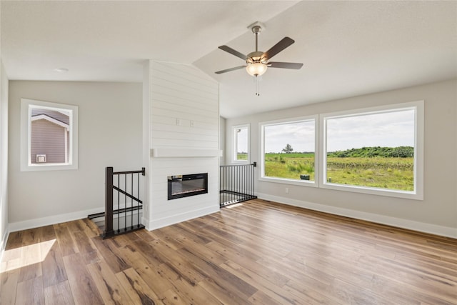 1430 Werthman Dr, Waukee, IA 50263 - unfurnished living room with vaulted ceiling, wood finished floors, ceiling fan, and a large fireplace