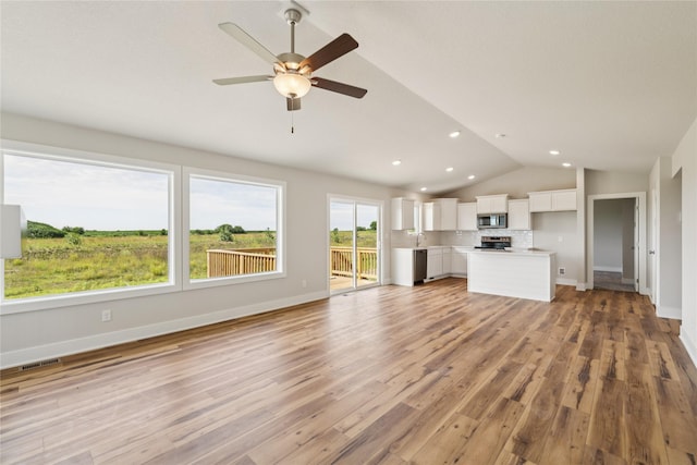 1430 Werthman Dr, Waukee, IA 50263 - unfurnished living room featuring vaulted ceiling, a ceiling fan, light wood-type flooring, and recessed lighting