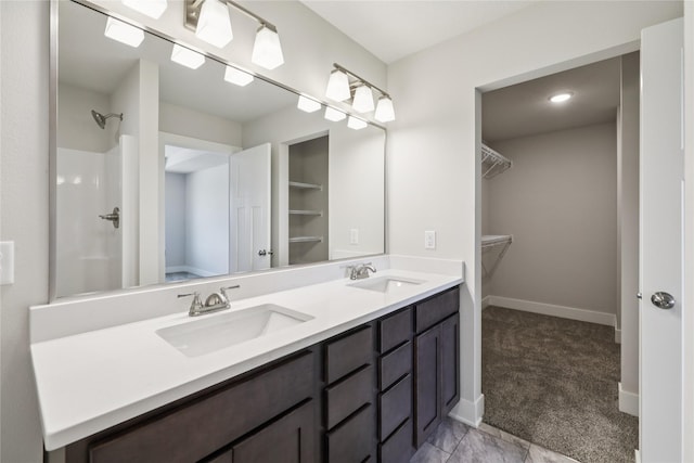 1430 Werthman Dr, Waukee, IA 50263 - bathroom with double vanity, a spacious closet, and a shower